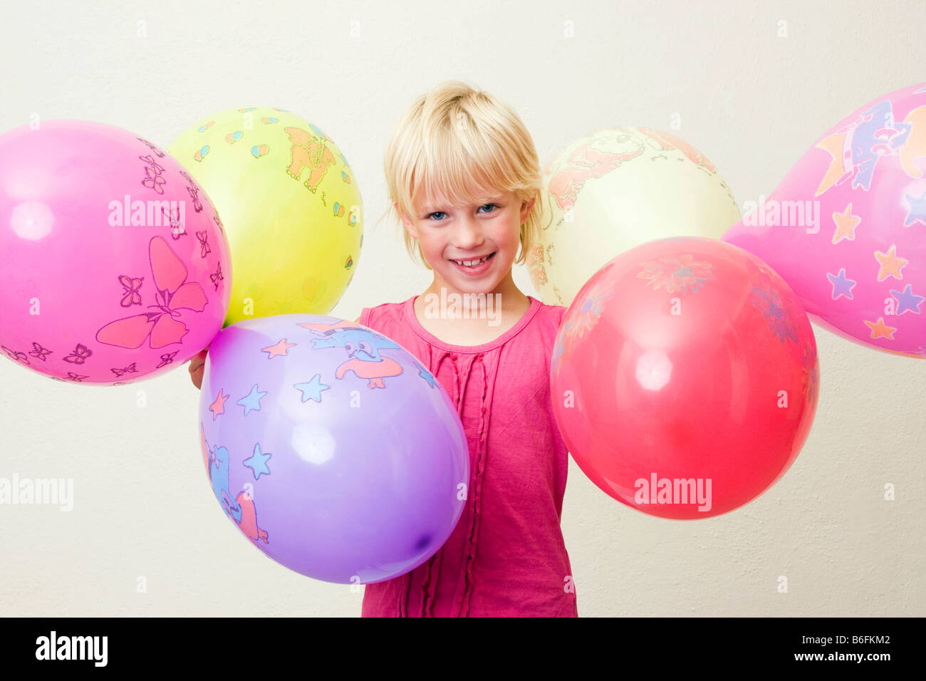 Girl, 7 years, with balloons Stock Photo