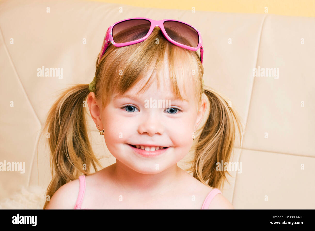Smiling blond little girl, 4 years, with sunglasses Stock Photo