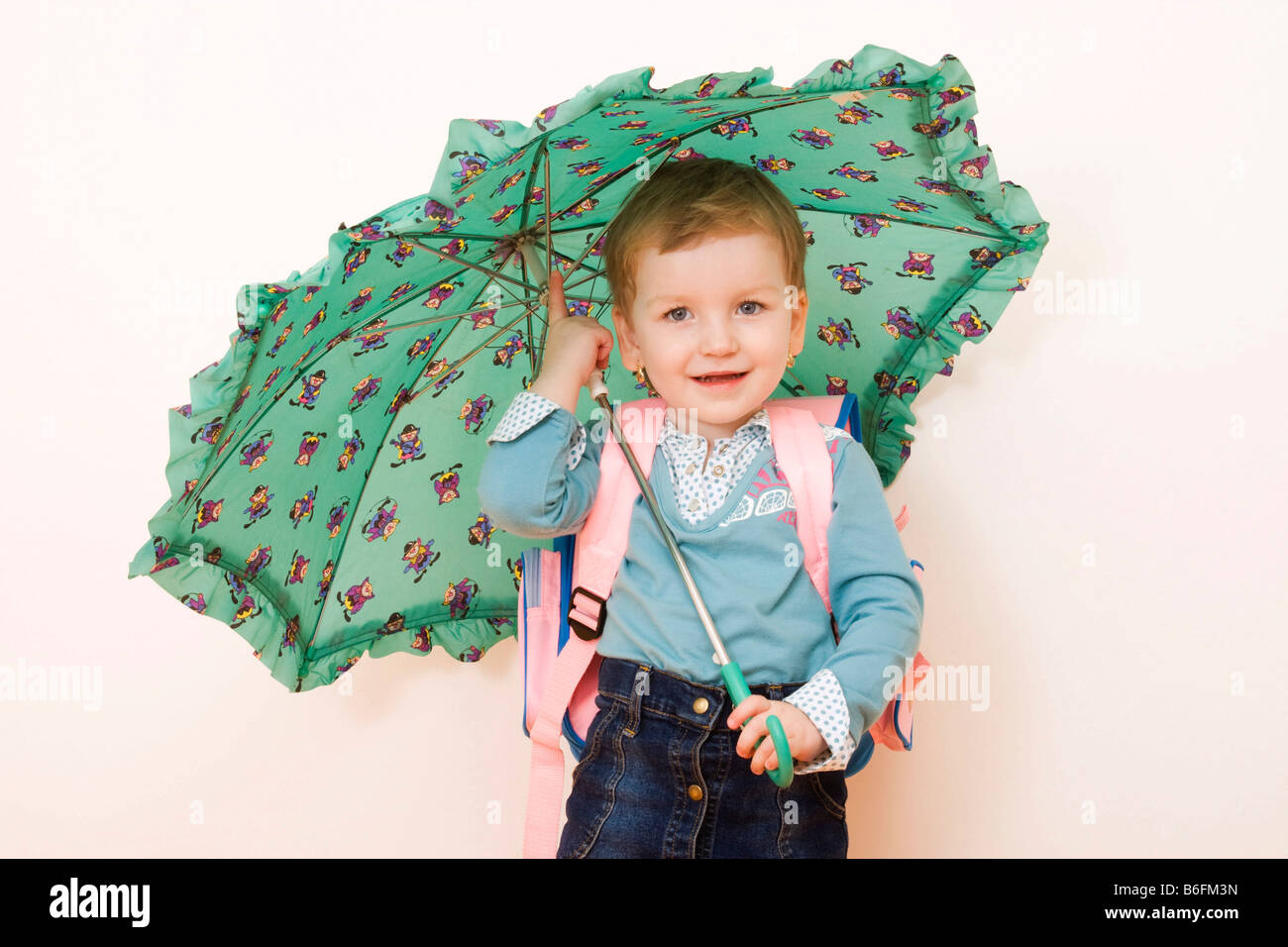 Little girl, 3 years, with umbrella and schoolbag Stock Photo