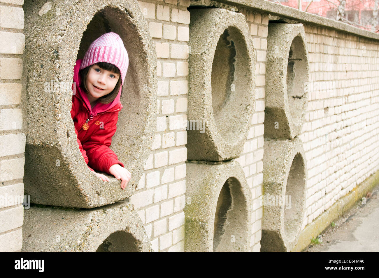 Little girl, 6 years, in a hidey-hole Stock Photo