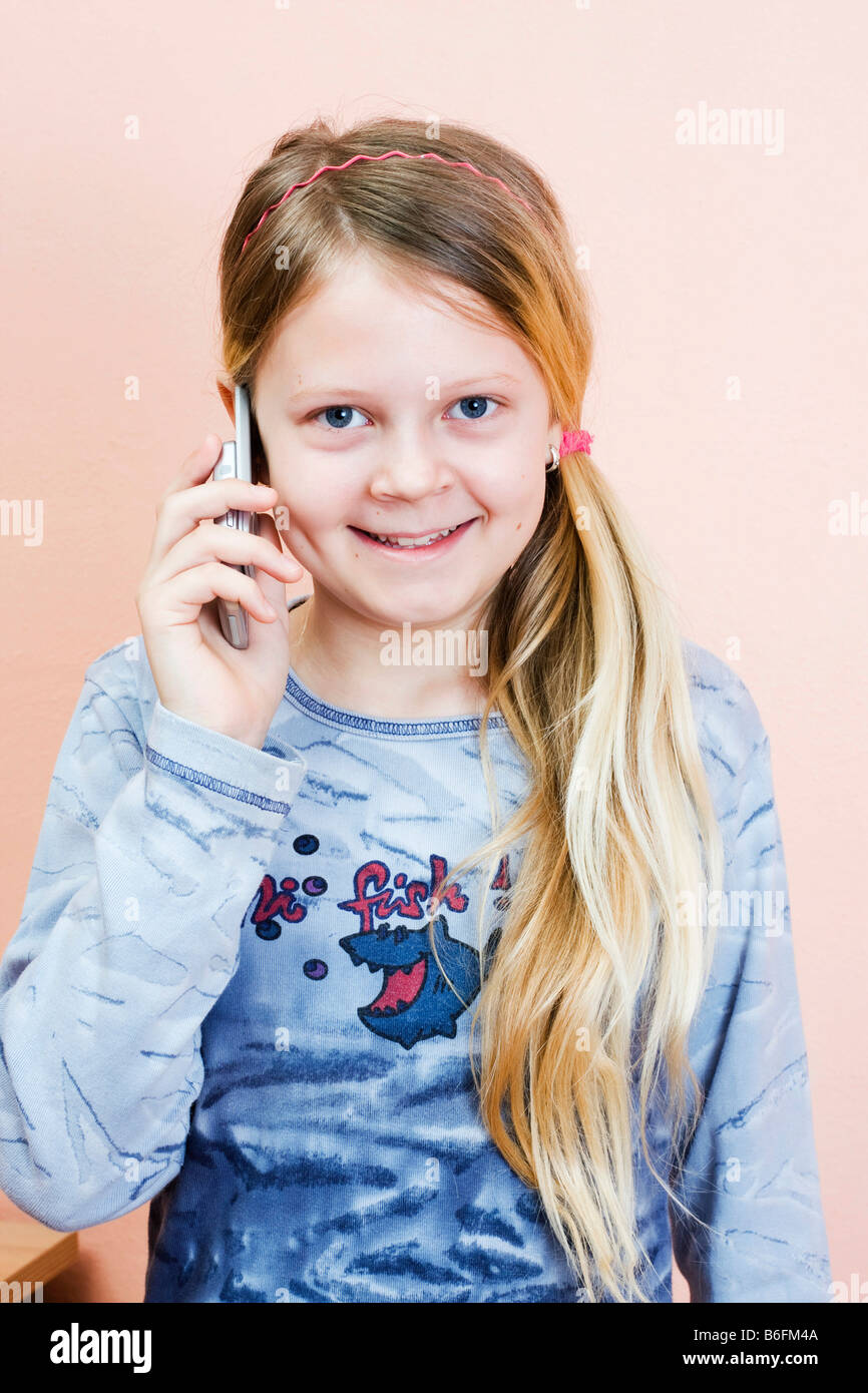 Telephoning girl, 11 years Stock Photo