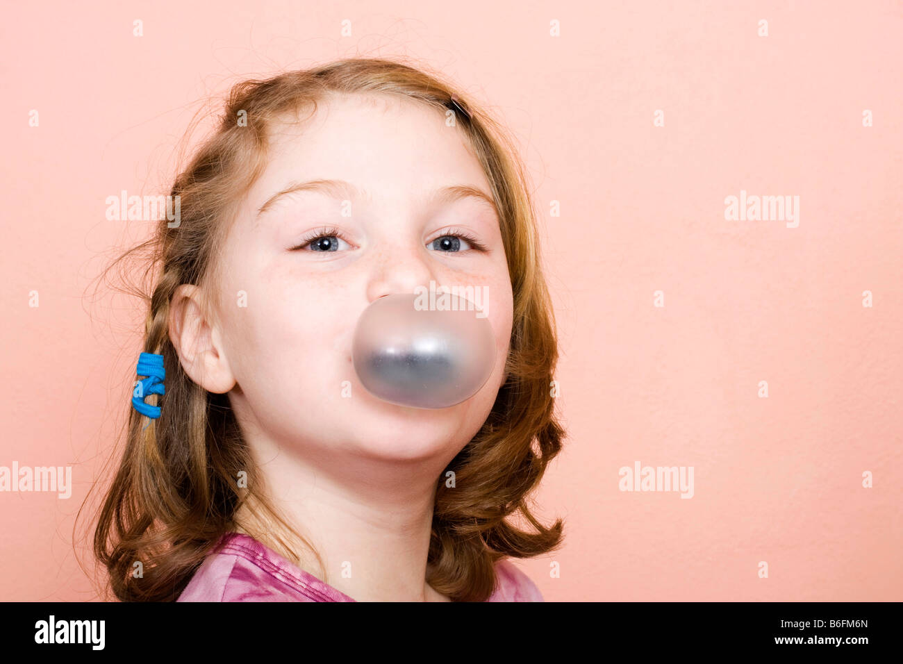 Little girl, 9 years, with chewing gum bubble Stock Photo