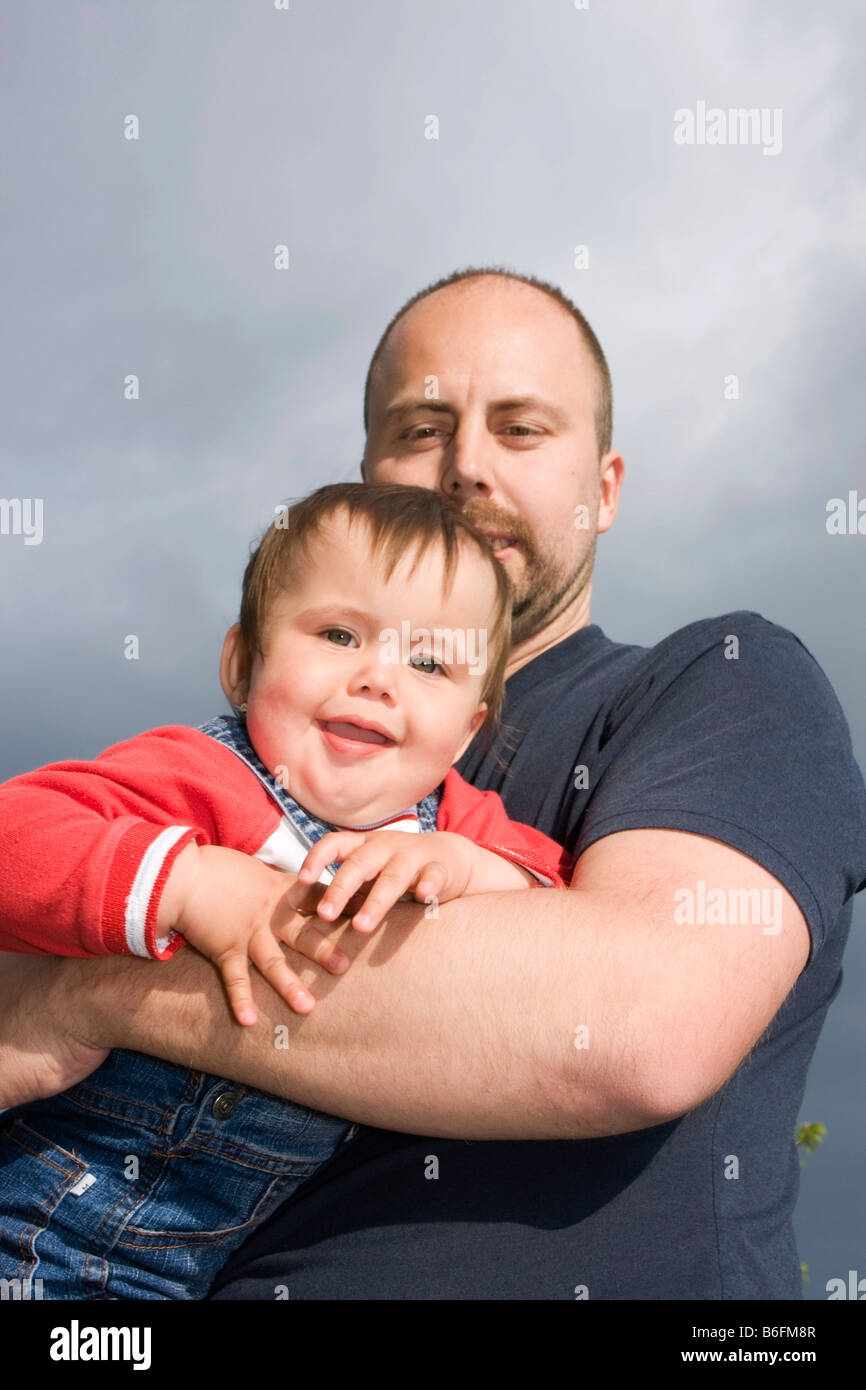 Father, 32 years old, and his smiling daughter, 14 months, outside Stock Photo