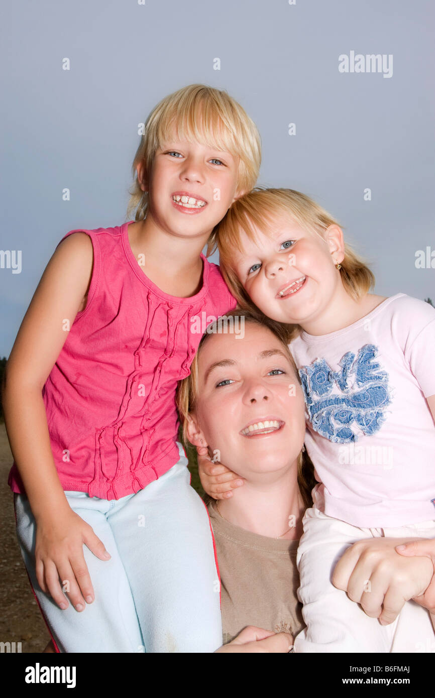 Mother, 33 years old, and two daughters, 5 and 7 years old Stock Photo