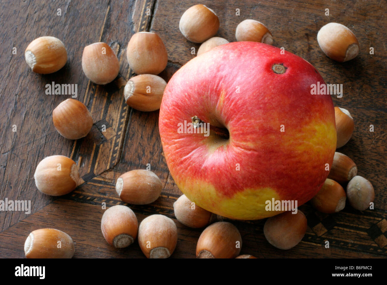 Wizened apple and hazelnuts Stock Photo Alamy