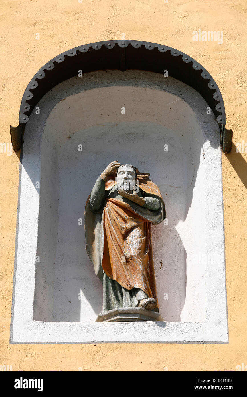 Saints figure with his head in his hands on St Albans Chapel in Diessen on Lake Ammersee, Pfaffenwinkel, Fuenfseenland, Upper B Stock Photo