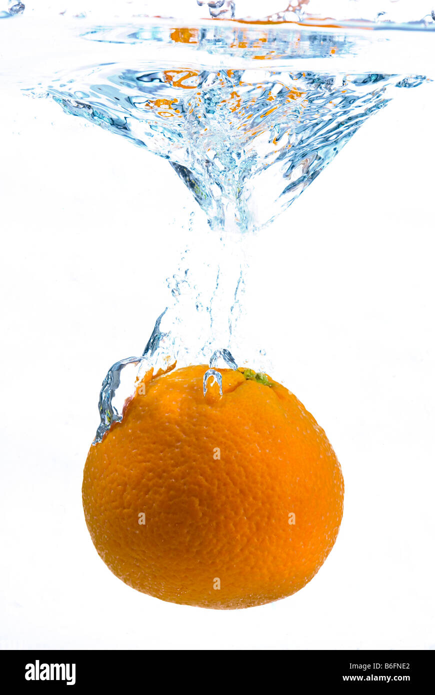 Orange falling into water Stock Photo