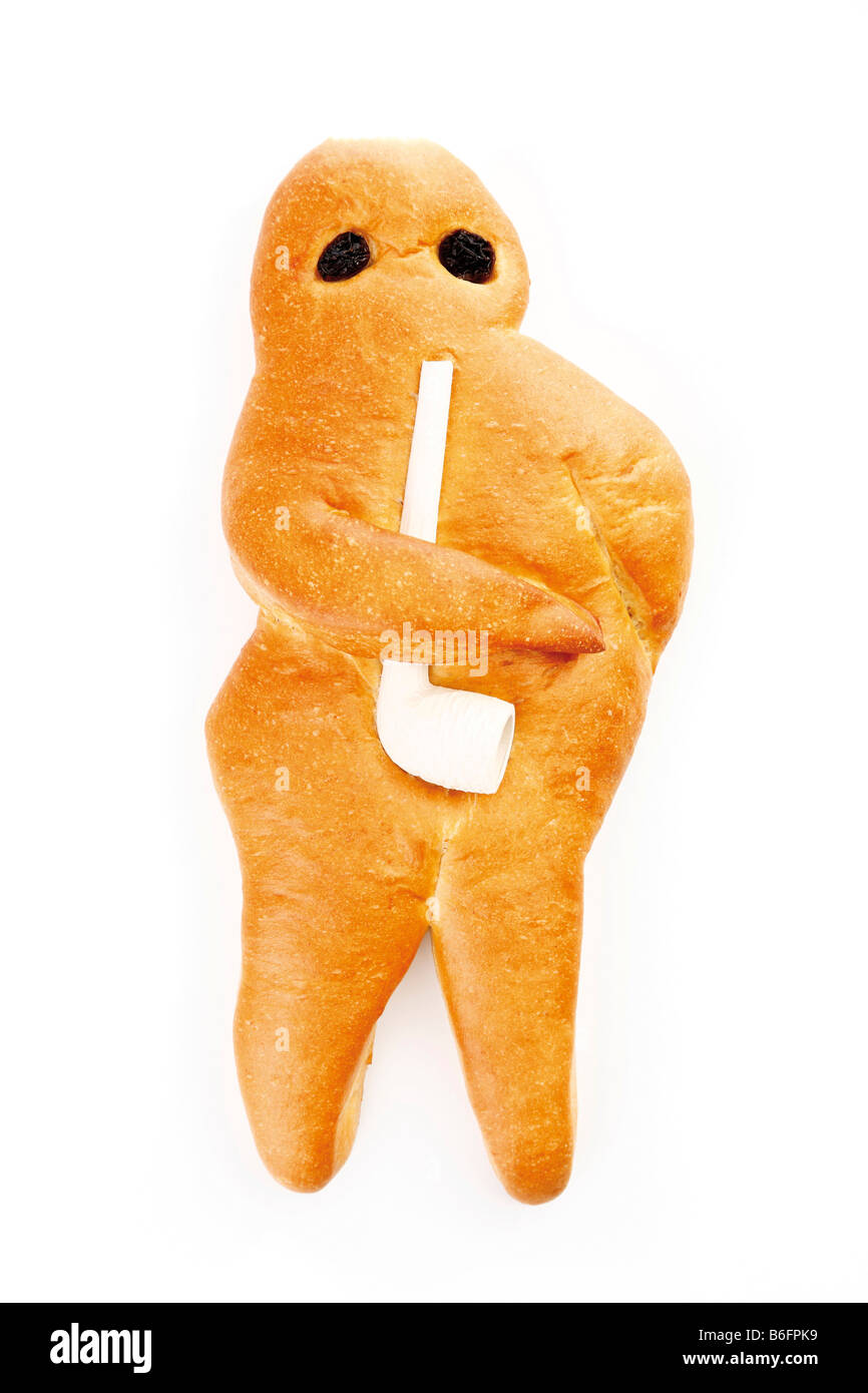 Weckmann, baked man from certain regions of Germany, made of sweet white dough, eyes of raisins, and carrying a pipe. Stock Photo