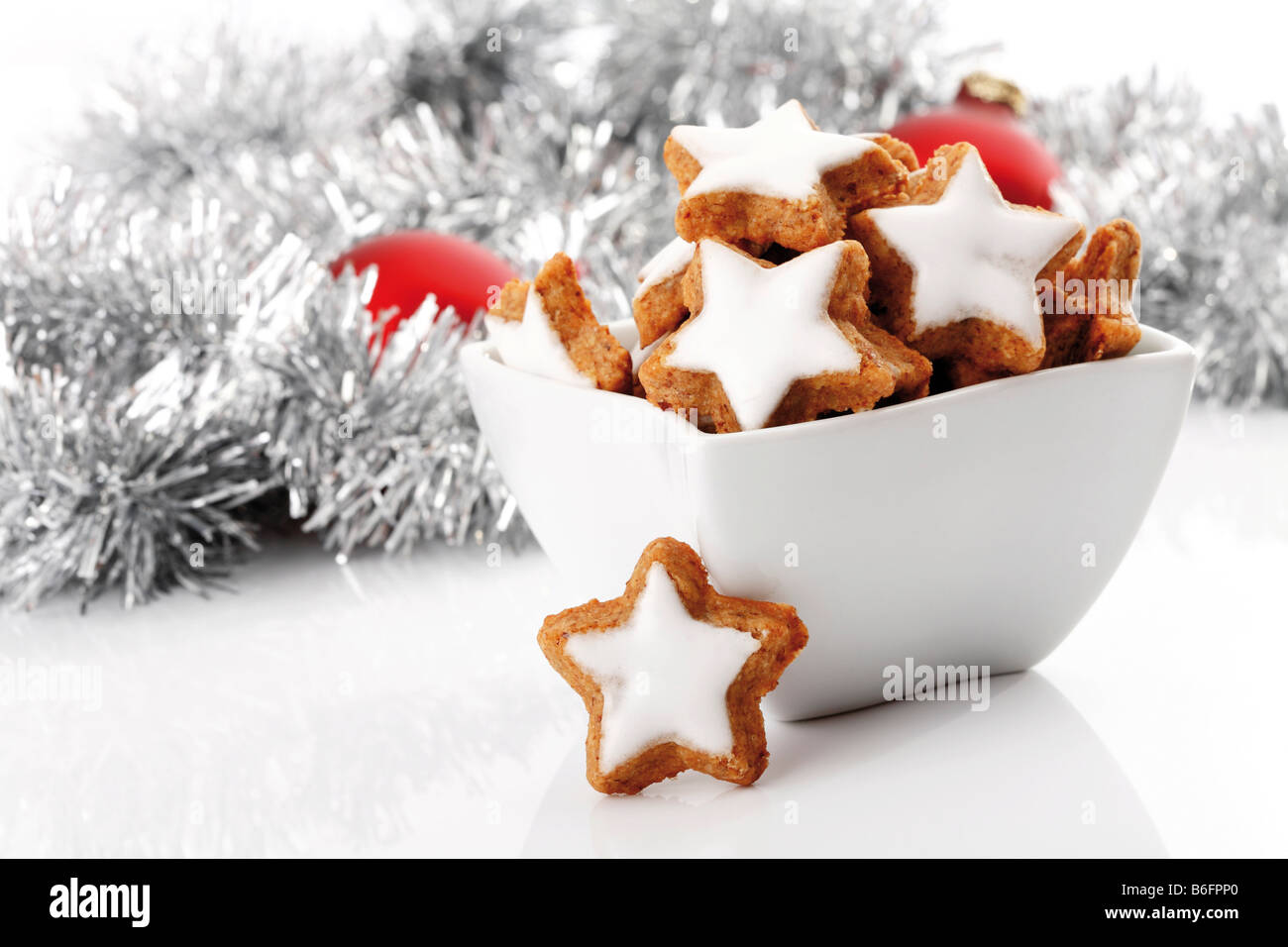 Cinnamon flavored star-shaped biscuits, christmas tree balls and decoration Stock Photo
