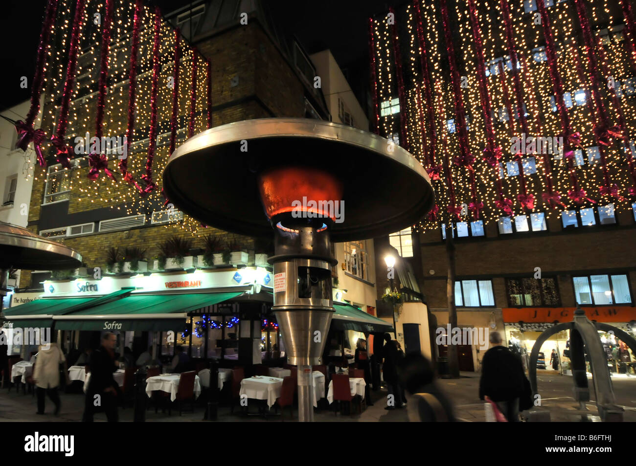 London West End evening night view Christmas time outdoor Calor gas heater at tables eating out similar to so called garden patio heaters England UK Stock Photo