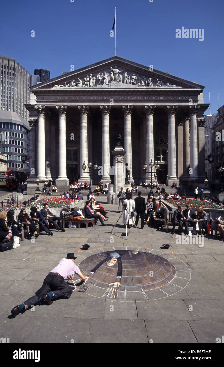 British optical illusion forced perspective trompe l'oeil street artist Julian Beever at work on chalk caricature on pavement Royal Exchange London UK Stock Photo