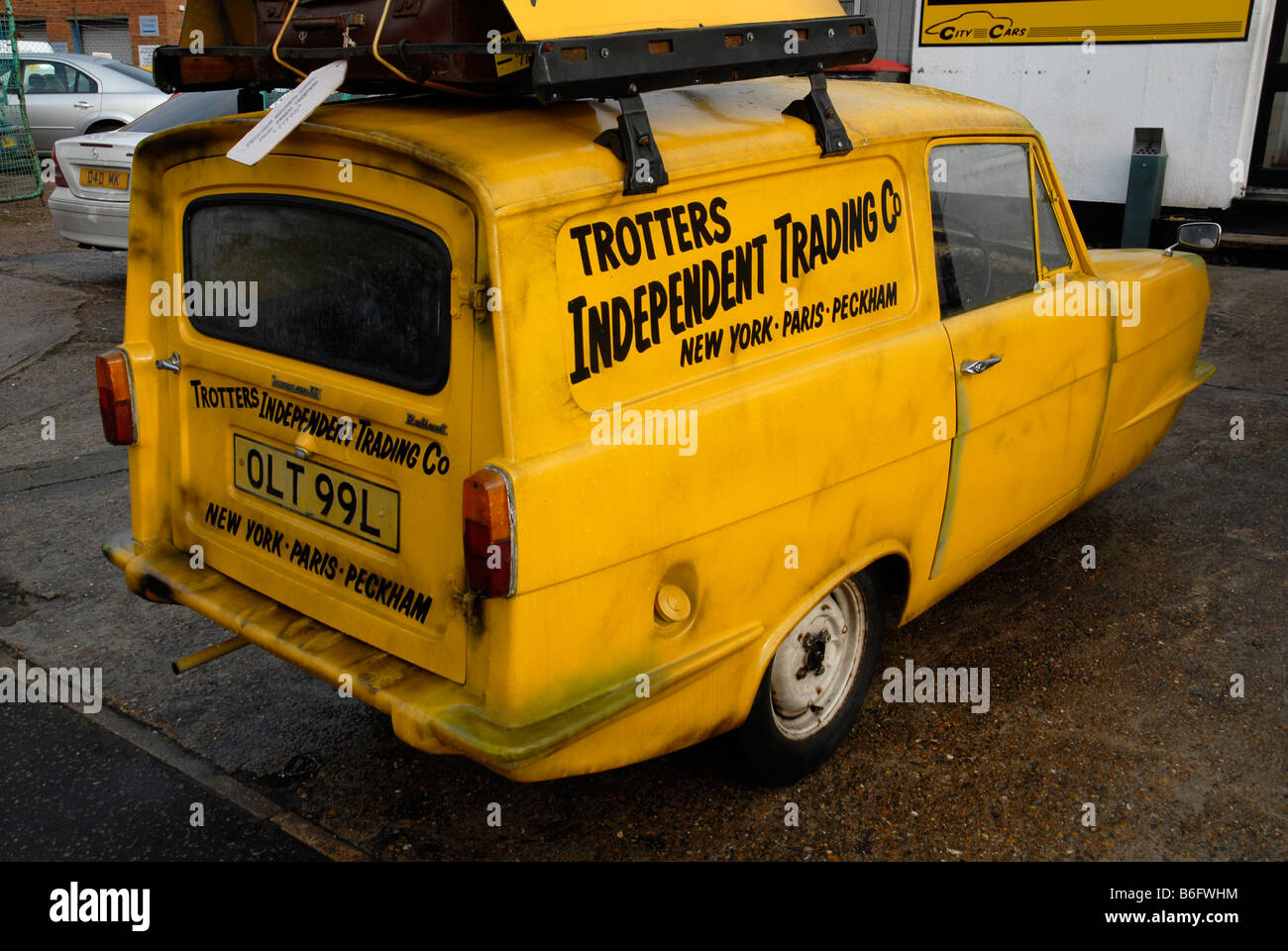 A reliant robin car painted with the logo of Trotters Independent Trading Co. Stock Photo