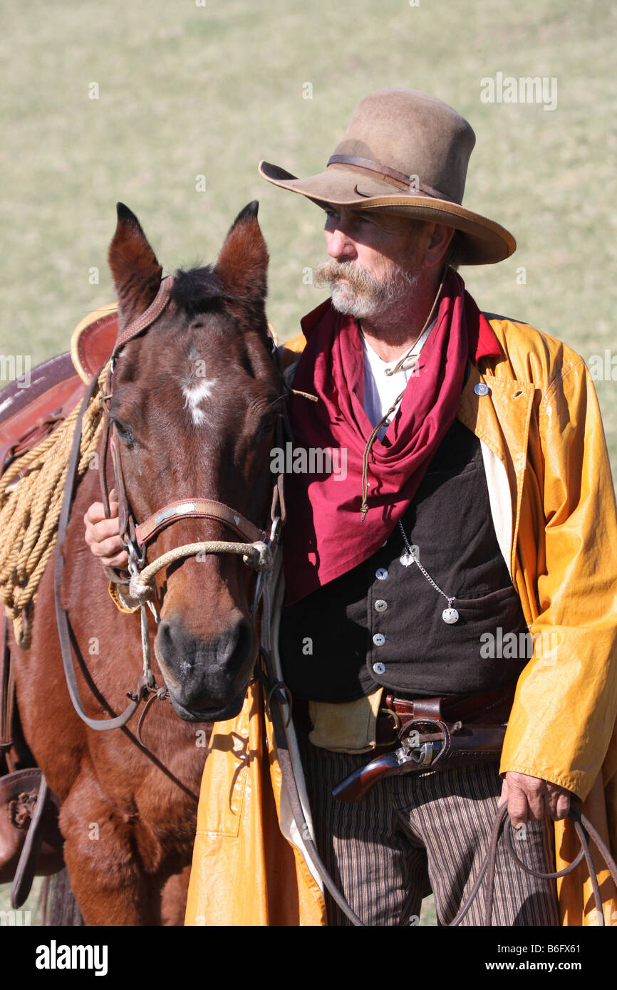 There is a bond between a cowboy and his horse out on the range Stock Photo