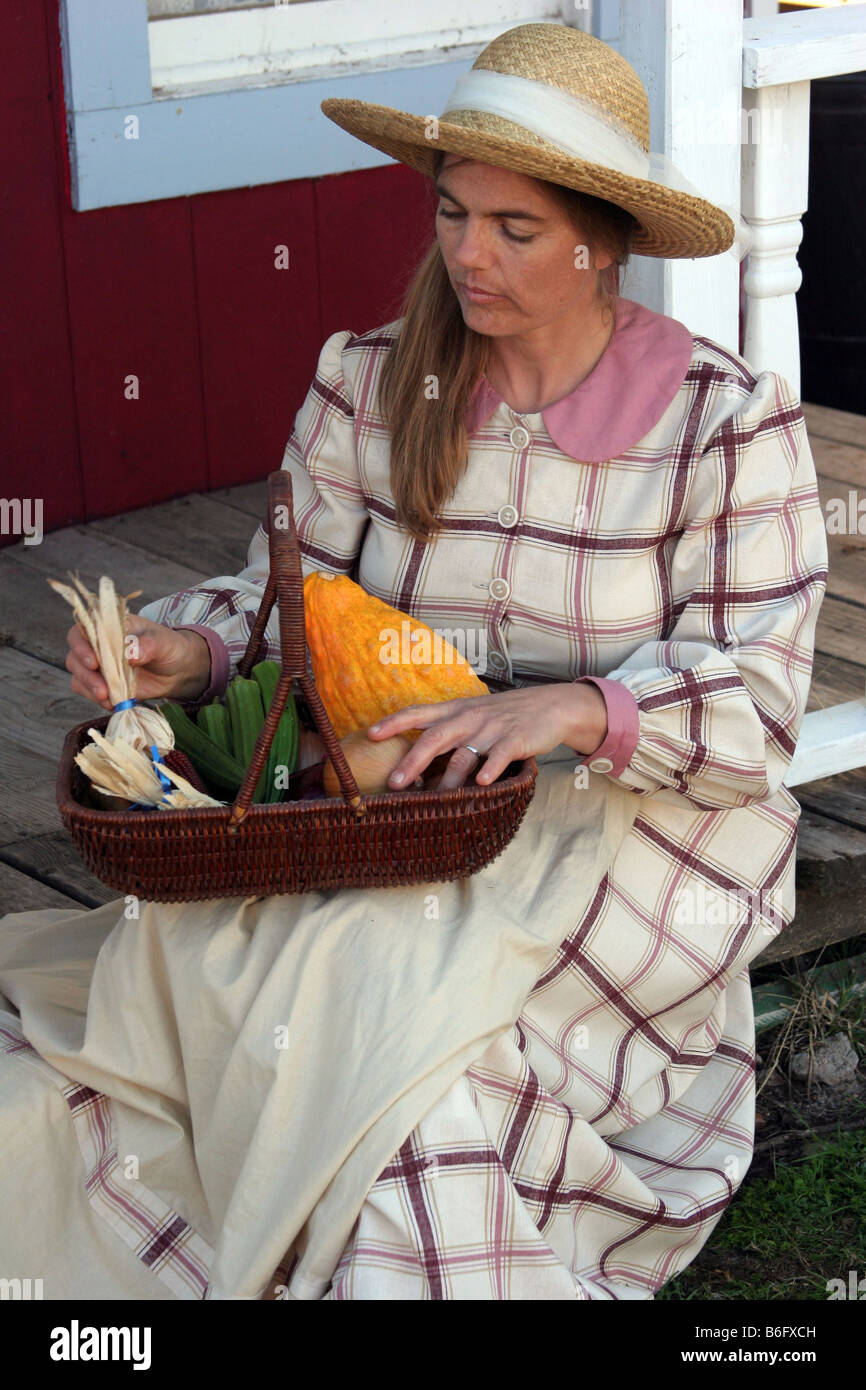 A lady going over her vegetables that she picked while sitting on the porch Stock Photo