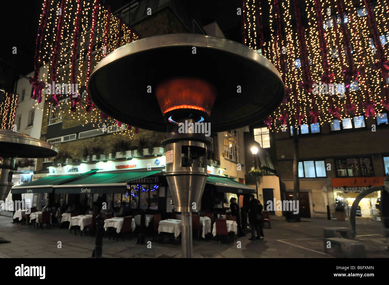 St Christophers Place London West End Christmas outdoor gas heater beside tables for eating out similar to so called garden patio heaters England UK Stock Photo