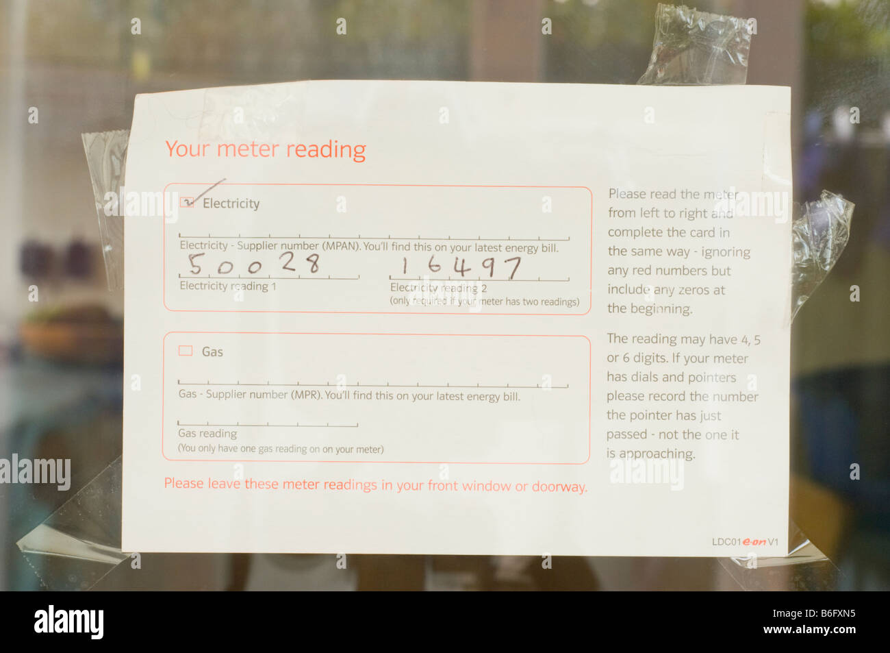 Electricity and gas meter reading card on window left out for meter reading man to read as he called when occupant was out Stock Photo