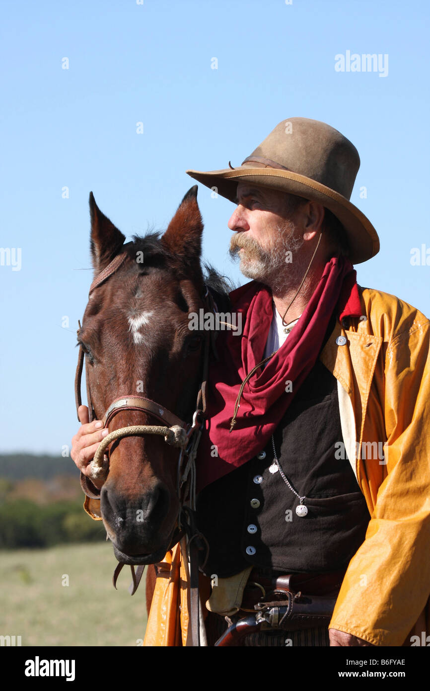 There is a bond between a cowboy and his horse out on the range Stock Photo