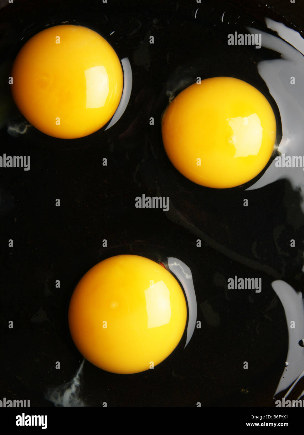 Three yolks close up view from above Stock Photo