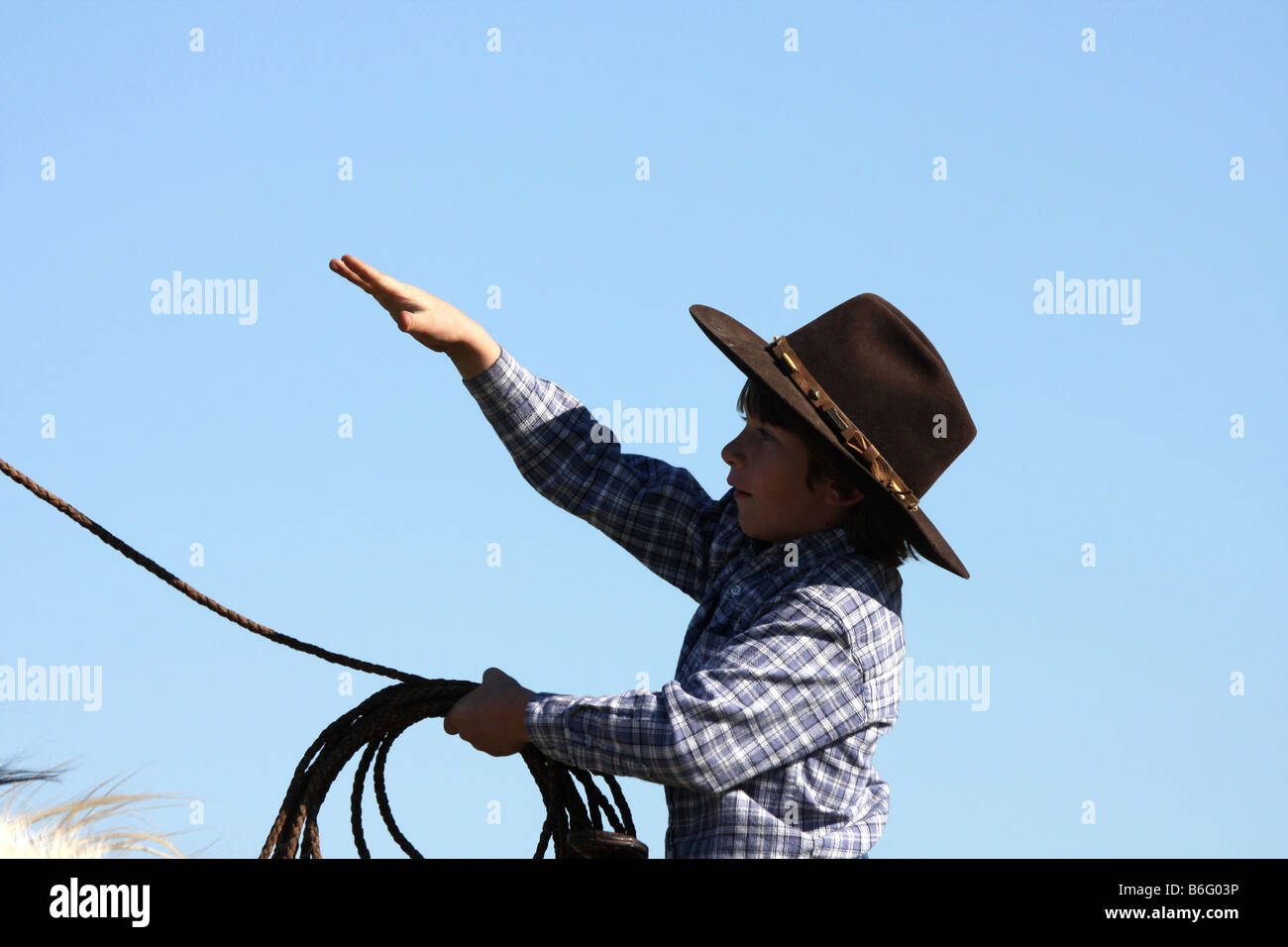 A young cowboy throwing the rope from horseback Stock Photo - Alamy