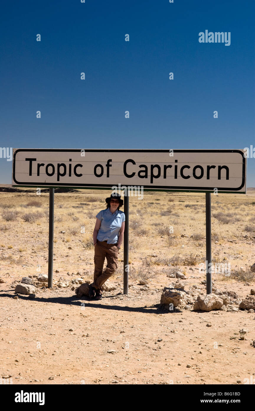 A traveller stops at the Tropic of Capricorn marker sign, Namibia Stock Photo