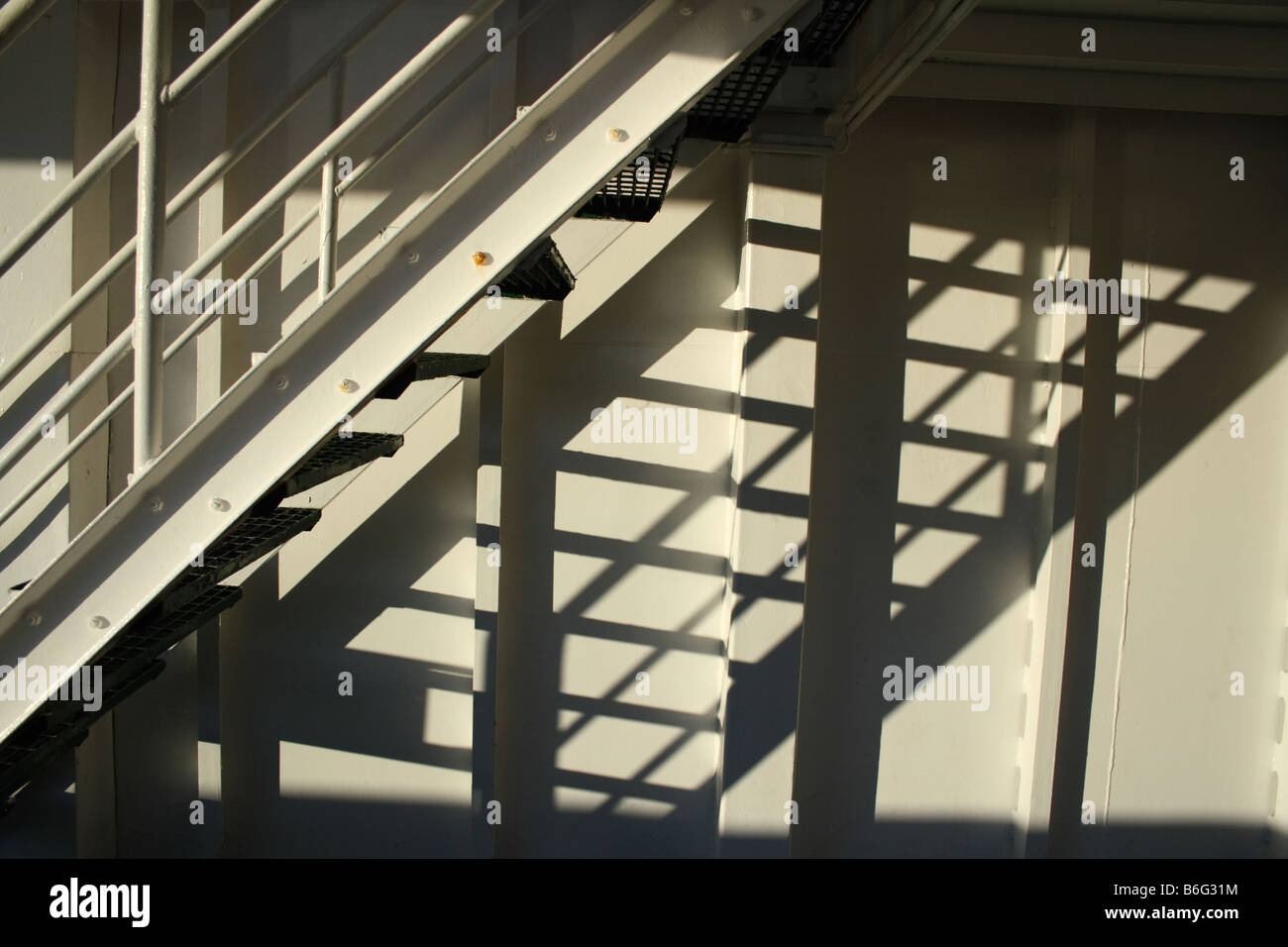 Stairs and a shadowy pattern on a wall Stock Photo - Alamy