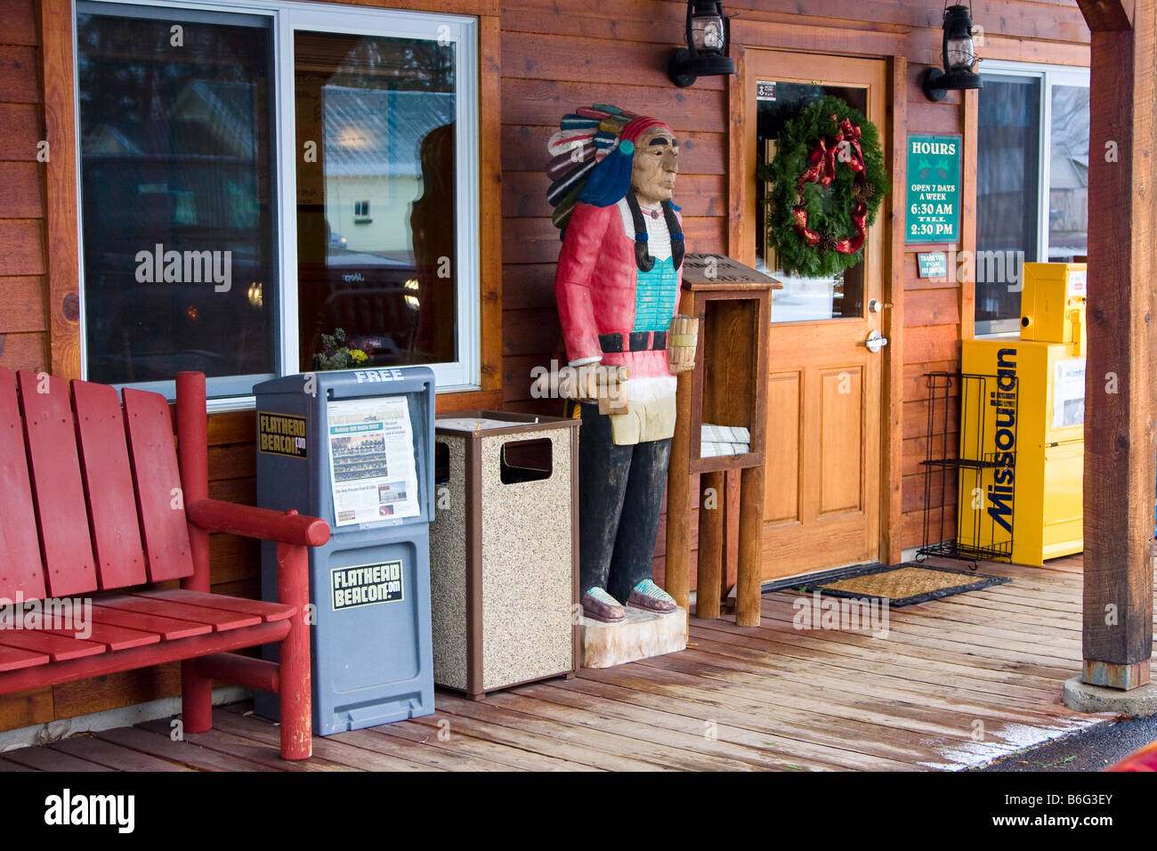Wood carved statue known as a Cigar Store Indian in front of a restaurant in Bigfork Montana Stock Photo