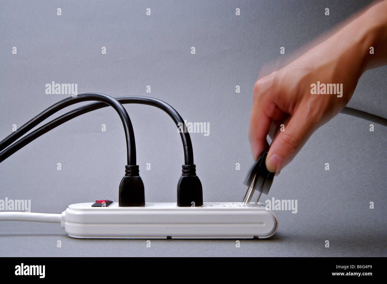 Hand plugging a plug into an outlet Stock Photo Alamy