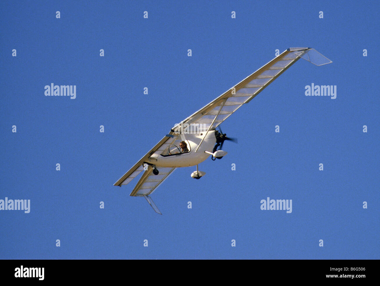 Ultralight experimental aircraft against clear blue sky. Stock Photo