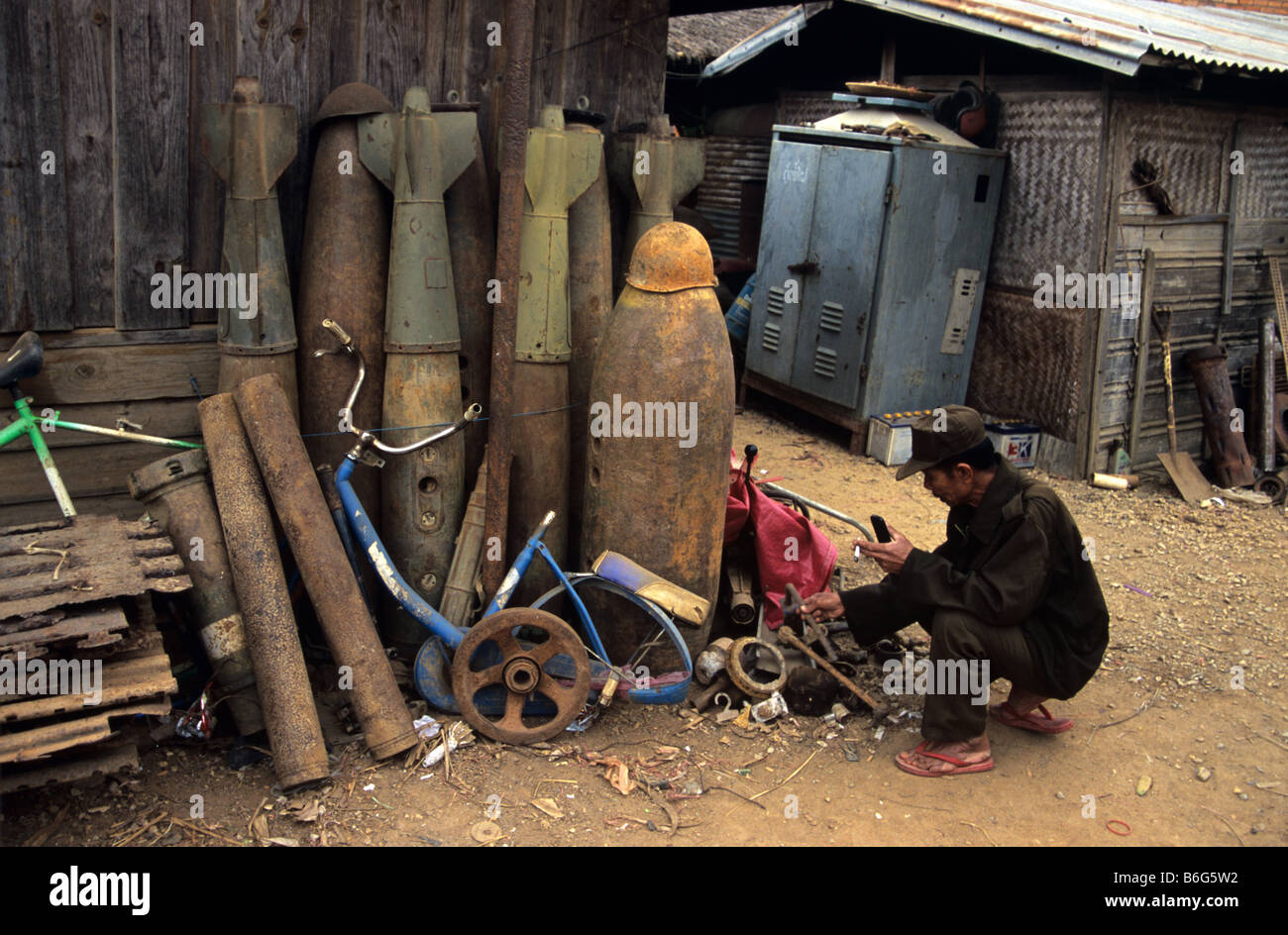 A scrap metal dealer and junk yard with US Vietnam war-era war scrap, cluster bomb casings and missiles, Phonsavan, Laos Stock Photo