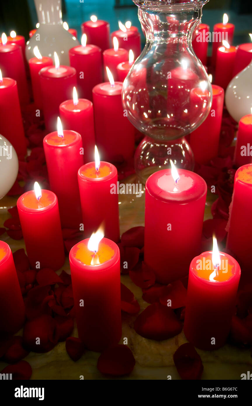 Lit red candles on table. Stock Photo