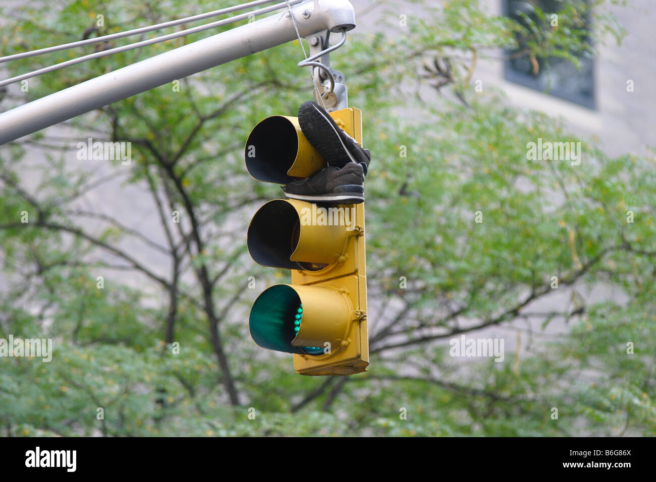 A pair of sneakers hanging on a set of traffic lights in New York Stock Photo