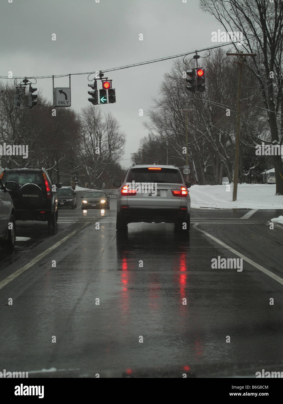 Automobile traffic stopped on cold wet winter day. Stock Photo