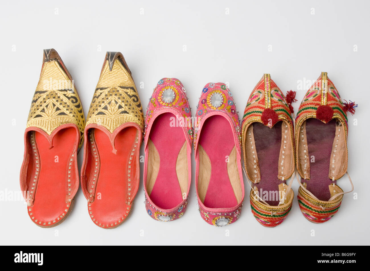 Close-up of three pairs of juttis in a row Stock Photo