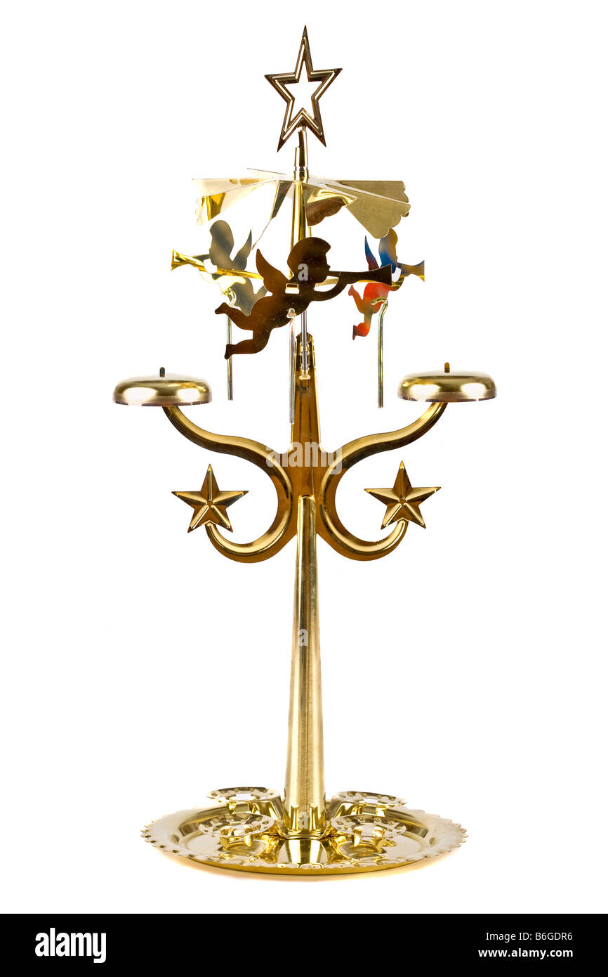 Spinning brass angel candle holder on white Stock Photo