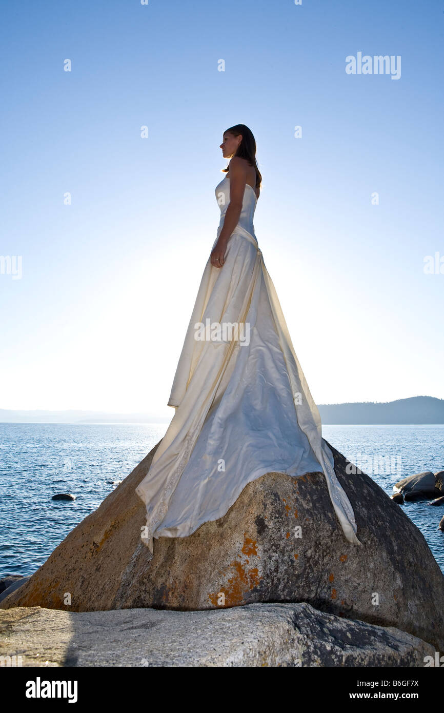 Bride In Wet Dress Standing Tall On Rock In Lake Stock Photo Alamy