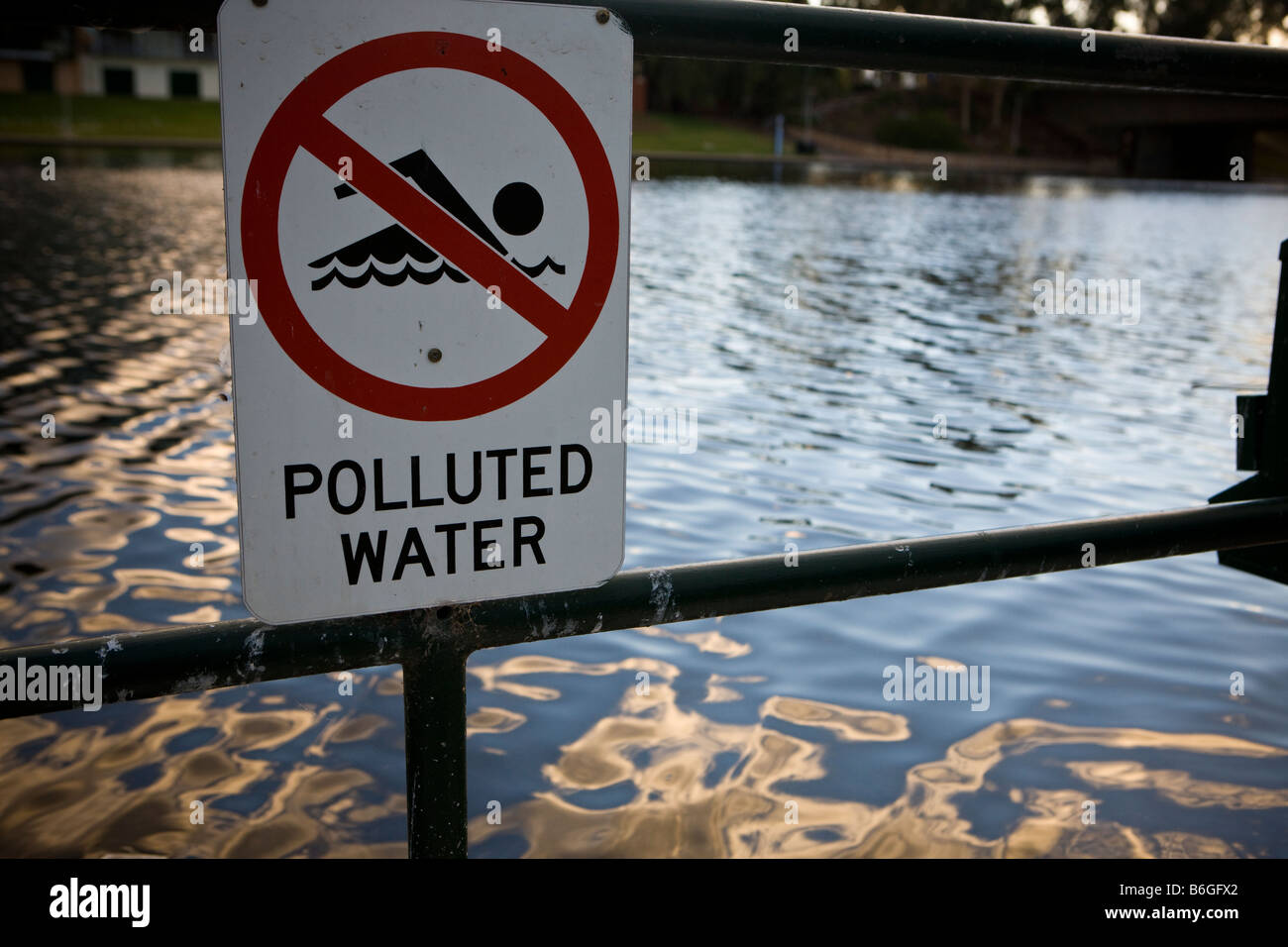 A warning sign prohibiting swimming due to polluted water, Torrens River, Adelaide, South Australia, Australia Stock Photo