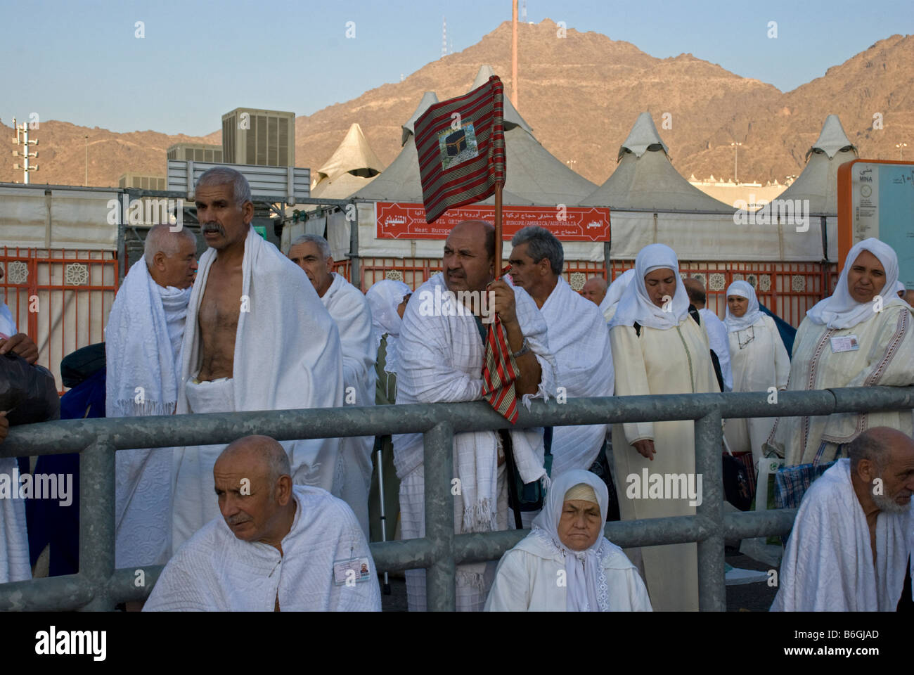 Muslim pilgrim waiving with a banner showing other members of his group where he is standing Makkah Saudi Arabia Stock Photo