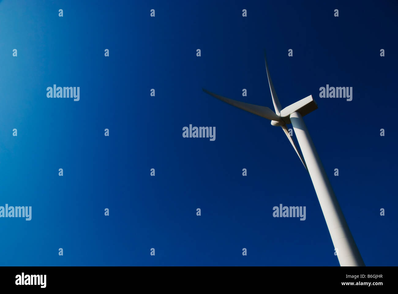 A Wind Turbine Against a Bright Blue Sky Stock Photo - Alamy