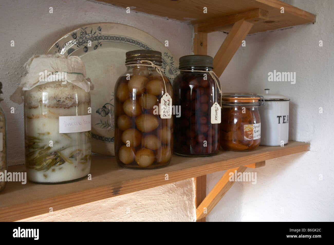 old fashioned traditional pickled food in jars in an old traditional country kitchen Stock Photo