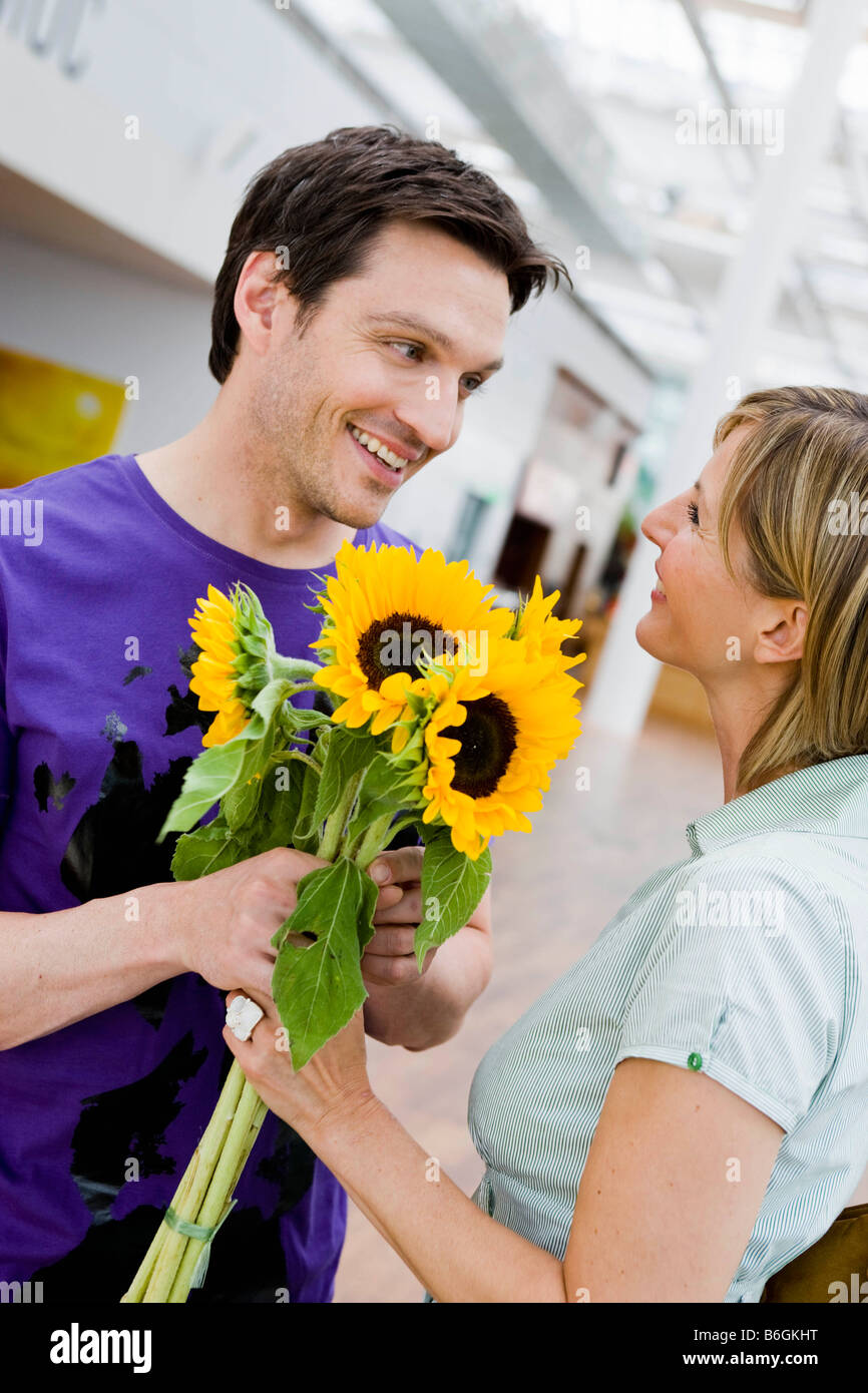 Man giving flowers to a woman Stock Photo Alamy