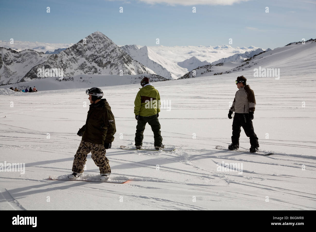 Three snowboarders having fun on the run down the glacier near Innsbruck Austria Stubaier gletscher Stock Photo