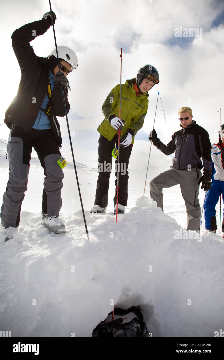 Skiers training to find a person buried by snow on an avalanche survival course Stock Photo