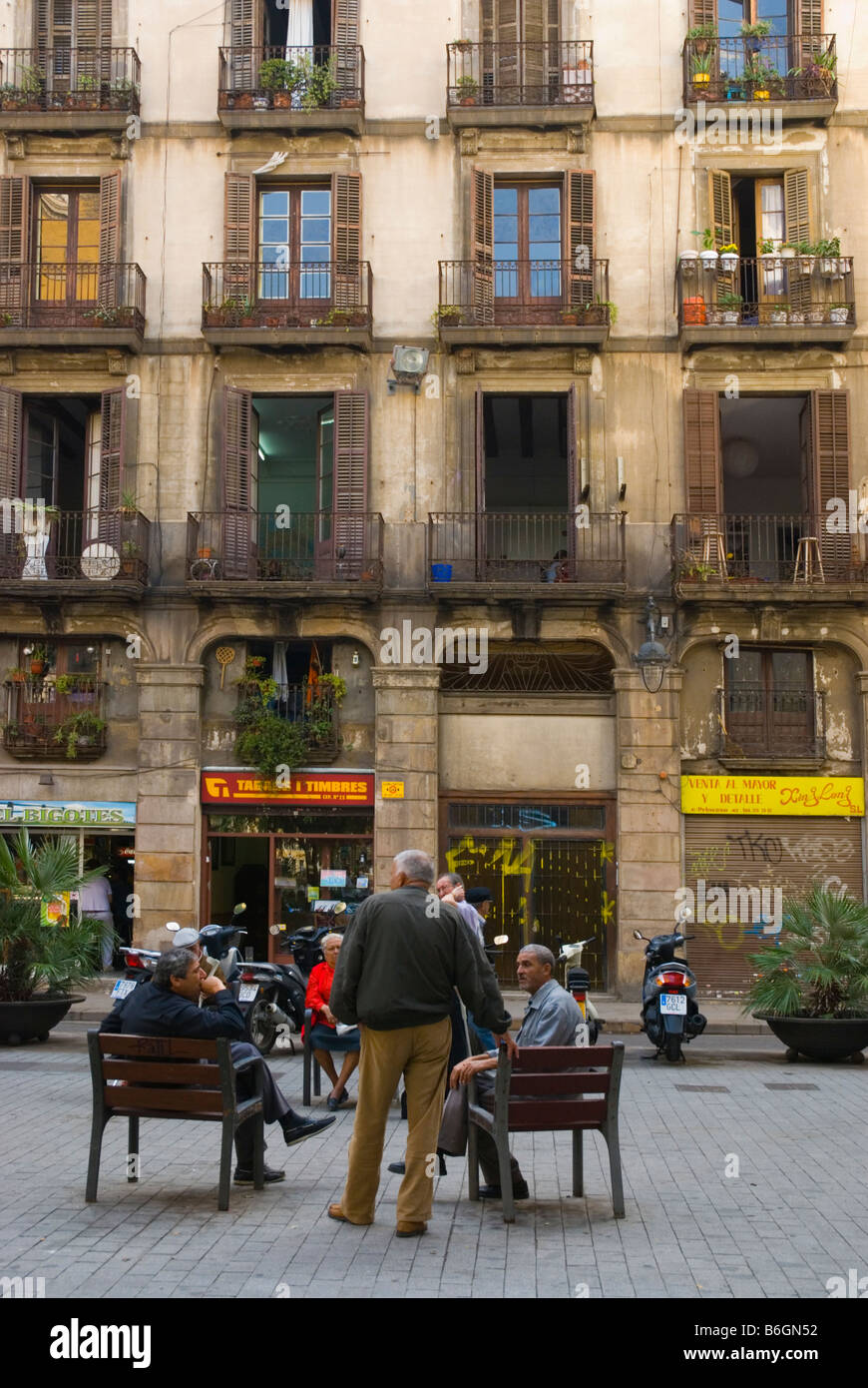 Men talking in Barri Gotic district of Barcelona Spain Europe Stock Photo