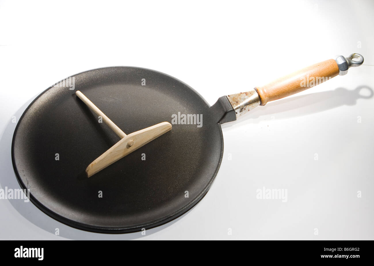 Crepe pancake pan with spreader Stock Photo Alamy