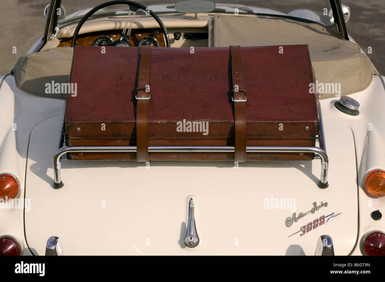 Leather suitcase on the rack of a 1960 s Austin Healey Stock Photo