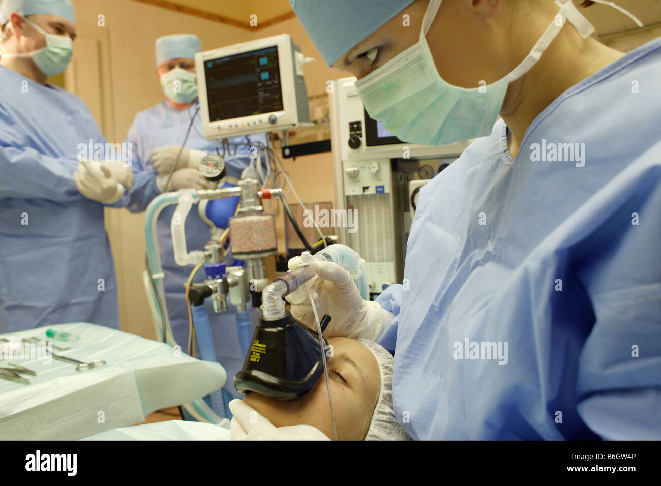 Physicians and nurses at work in the operating room Stock Photo