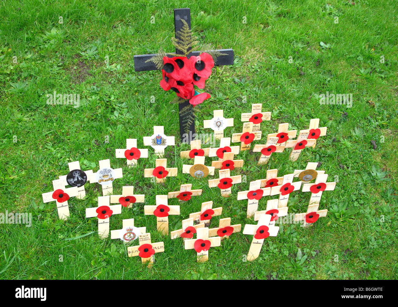 Personal poppy remeberance crucifixes in churchyard on Rememberance Sunday Stock Photo