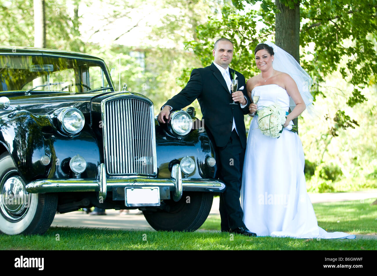 Bride and Groom with Limo Stock Photo