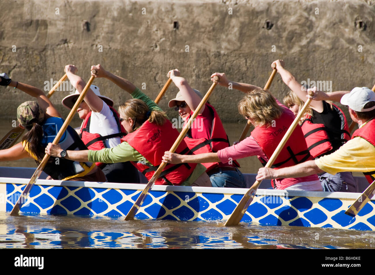 Dragon boat tourists learn to paddle Buffalo Bayou, Allen's Landing, downtown Houston, Texas