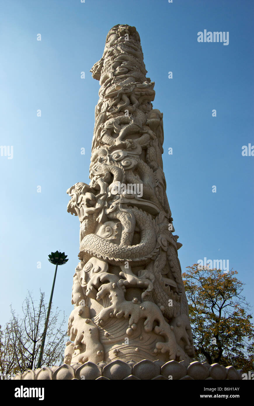 Marble column decorated in sculpted dragons in Buddhist Tianning Temple complex Stock Photo